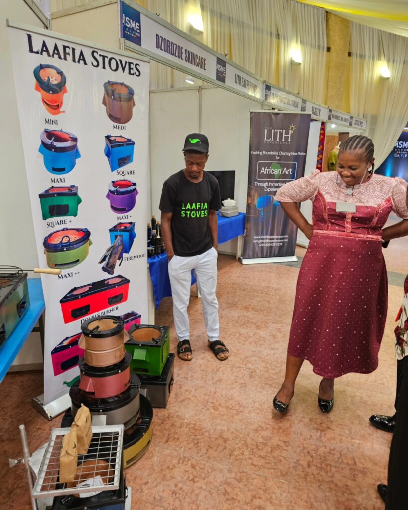 Methanogreen exhibitor and visitor beside the Laafia stove range